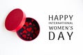 Red hearts in a round red inside black box and Happy 8 March International Women`s Day lettering