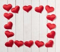 Red Hearts of satin fabric as framework for a words message.  It`s blank in the center and has white shiplap boards background Royalty Free Stock Photo