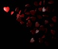 Red hearts scattered on the black background