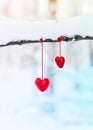 Red hearts on snowy tree branch in winter. Holidays happy valentines day celebration heart love concept. Royalty Free Stock Photo