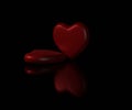 Red hearts and their reflections on black background Royalty Free Stock Photo