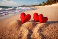 Red hearts together on the beach, showing holiday summer romance