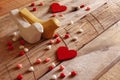 Red hearts and two loving birds on wooden table