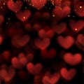 Red hearts valentine day defocused bokeh lights on a black background with confetti Royalty Free Stock Photo