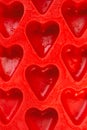 Red hearts vertical background, silicone ice molds in the form of hearts Royalty Free Stock Photo