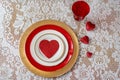 Red hearts on white lace for Valentine`s Day place setting Royalty Free Stock Photo