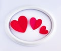 Red hearts in a white oval frame. Holidays. Valentines Day concept Royalty Free Stock Photo