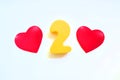 red hearts yellow number two on a white background