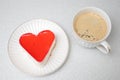 Red heart shaped cake for St. Valentines Day celebration with cup of coffee Royalty Free Stock Photo