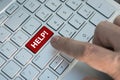 Red help button on the keyboard close-up. A male finger presses a color button on a gray silver keyboard of a modern laptop. Butto Royalty Free Stock Photo