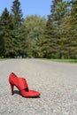 Red high heel shoe on road Royalty Free Stock Photo