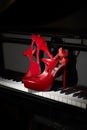 Red high heel shoes on piano