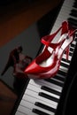 Red high heel shoes on piano