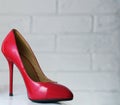 Red high-heeled shoes. Women's shoes with heels. A pair of women's red patent leather shoes on a white background