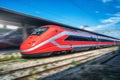 Red high speed train in motion on the railway station Royalty Free Stock Photo