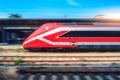 Red high speed train in motion on the railway station Royalty Free Stock Photo