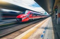 Red high speed train in motion on the railway station Royalty Free Stock Photo