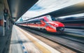 Red high speed train in motion on the railway station Royalty Free Stock Photo