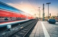 Red high speed train in motion on the railway station Royalty Free Stock Photo