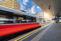 Red high speed train in motion on the railway station at sunset Royalty Free Stock Photo