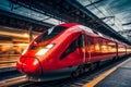 Red high speed train in motion on the railway station at sunset Royalty Free Stock Photo