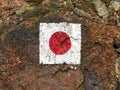 Red hiking marker symbol at a quarry stone wall in germany Royalty Free Stock Photo