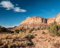 Red Hills of Eroded Sand and Clay Below the Steep Cliffs of the Waterpocket Fold Royalty Free Stock Photo