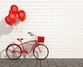 Red hipster bicycle with balloons in front of wall