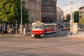 Red historic tramway turning on the street of Prague
