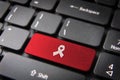 Red HIV ribbon keyboard key, Health background Royalty Free Stock Photo