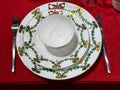 Red holiday table setting with plates and silverware. Royalty Free Stock Photo