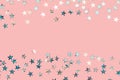 Red holographic star glitter confetti background on pink Royalty Free Stock Photo