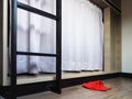 Red home fabric disposable slippers on wooden floor tile in bedroom Royalty Free Stock Photo