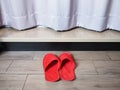 Red home fabric disposable slippers on wooden floor tile Royalty Free Stock Photo