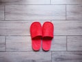 Red home fabric disposable slippers on wooden floor tile Royalty Free Stock Photo