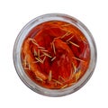 Red homemade oven dried tomatoes with rosemary stuffed with olive oil in a glass jar, top view, close-up, isolated Royalty Free Stock Photo