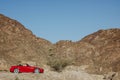 Red sports car in countryside 