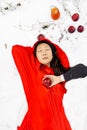 Red Hooded Woman Holding an Apple Fairytale Portrait in winter forest. Royalty Free Stock Photo