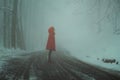 Red hooded woman in a snowy road