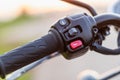 Red horn switch. Left handle bar with hand clutch of motorcycle. Motorcycle maintenance concept outdoor shooting with sunset