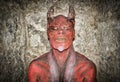 Red horned face demon on a concrete wall Royalty Free Stock Photo