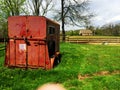 Red horse trailer in a field