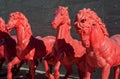 Red horses sculptures, in a row