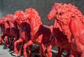 Red horses sculptures, in a row