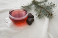 Red hot aromatic tea made from forest fruits or herbal or apples or red fruits in the glass cup on a white blanket. Royalty Free Stock Photo