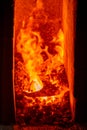 A red-hot ax on coals in a forge Royalty Free Stock Photo