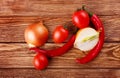 Red hot cherry and chili peppers over white wooden background onion Royalty Free Stock Photo