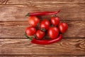 Red hot cherry and chili peppers over white wooden Royalty Free Stock Photo