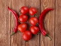 Red hot cherry and chili peppers over white wooden Royalty Free Stock Photo