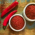 Red hot chili Cayenne pepper fresh and dried powdered spice, ready to use. Royalty Free Stock Photo